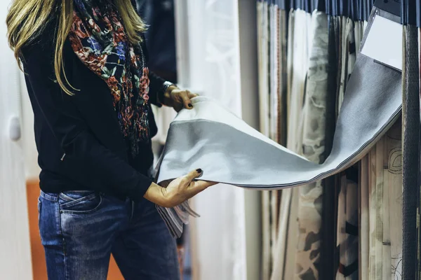 Designer choosing fabric for curtains
