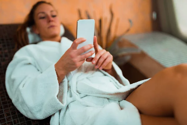 Woman Bathrobe Lying Tepidarium Bed Using Smart Phone — Stock Photo, Image