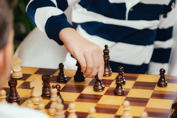 Little friends playing chess, having fun.