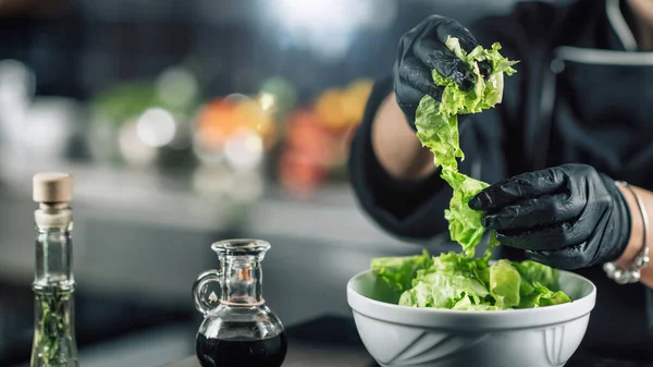 Female chef making healthy vegan salad