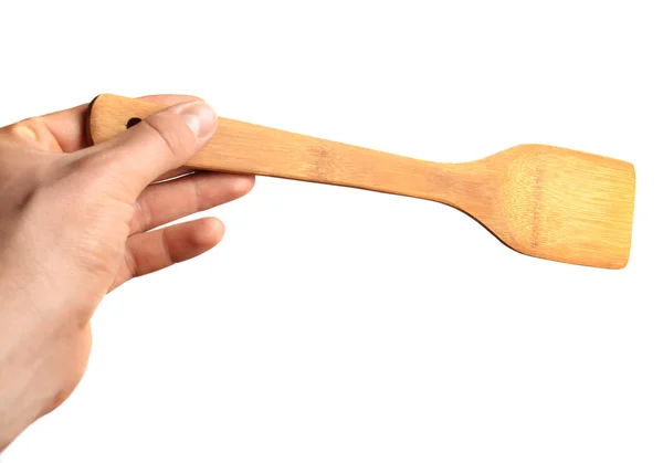 Espátula de madeira para fritar na mão isolada sobre fundo branco — Fotografia de Stock