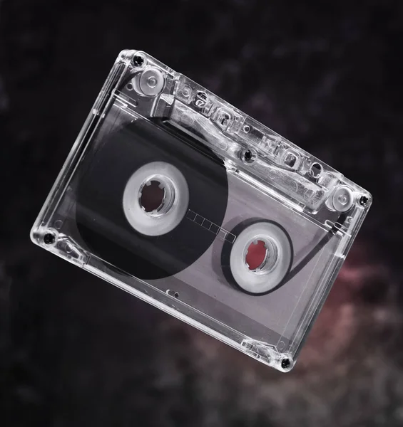 Audio cassette levitation. Retro media technology from the 80s. Mystical light.