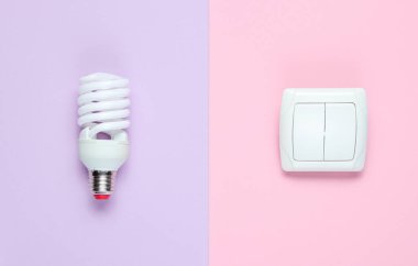 Ekonomi ampulü, pastel arka planı aç. Üst Manzara. Minimalizm elektro tüketici kavramı