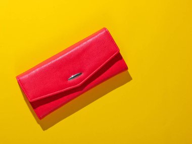 Sarı arka planda kırmızı deri cüzdan. Üst görünüm