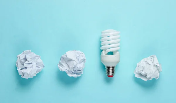 Energy Saving Light Bulb Crumpled Paper Balls Blue Background Minimalistic — Stock Photo, Image