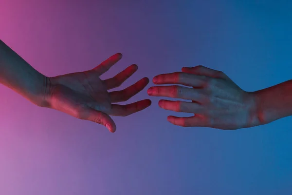 Duas Mãos Estendem Uma Outra Com Uma Luz Néon Vermelho — Fotografia de Stock