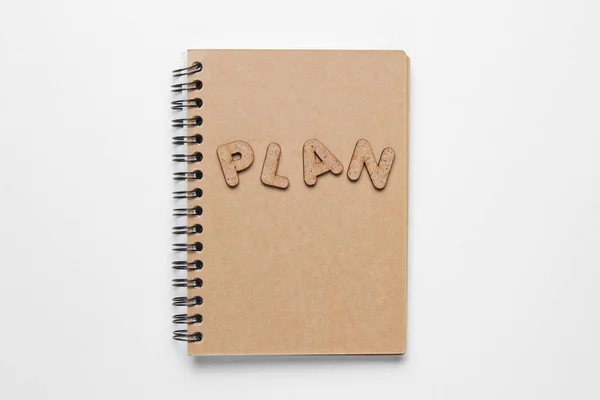 I have an plan! Notebook with craft paper with word PLAN on white background.