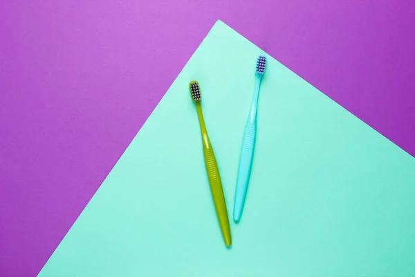 Two New Toothbrushes Purple Blue Paper Background Minimalism Hygiene Concept — Stock Photo, Image