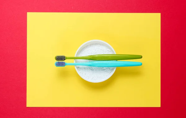 Two Toothbrushes Tooth Powder Yellow Red Background Minimalism Oral Hygiene — Stock Photo, Image