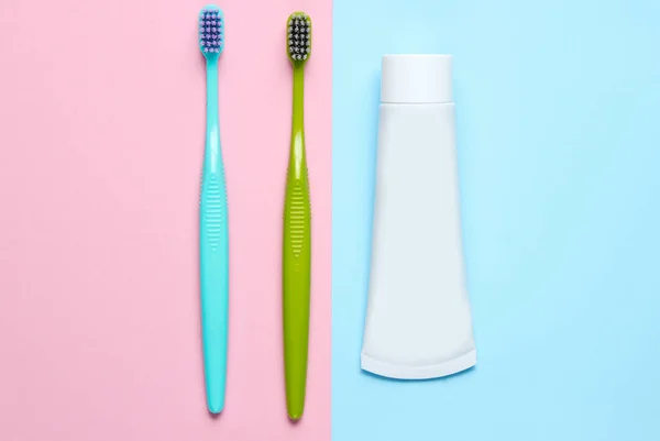 Two Toothbrushes Tube Toothpaste Pastel Background Top View — Stock Photo, Image