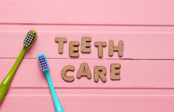 Teeth Care Concept Two Toothbrushes Pink Wooden Background Top View — Stock Photo, Image