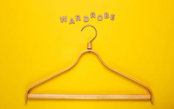 Wooden Hanger Yellow Background Word Wardrobe Top View — 스톡 사진