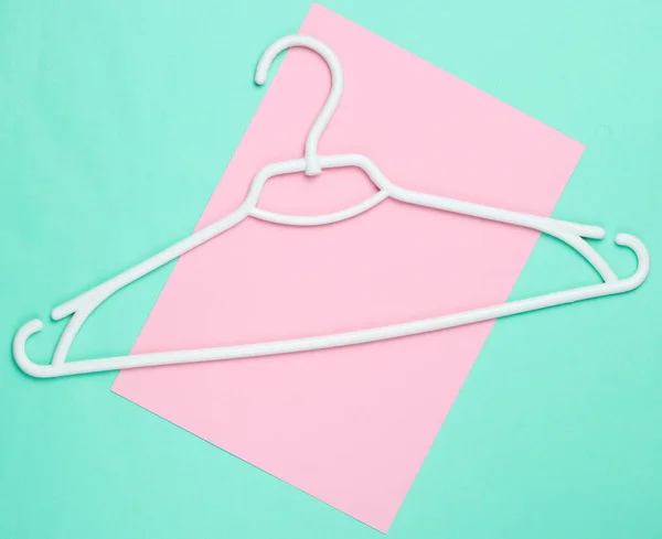 White Plastic Hanger Blue Pink Background Top View — 스톡 사진
