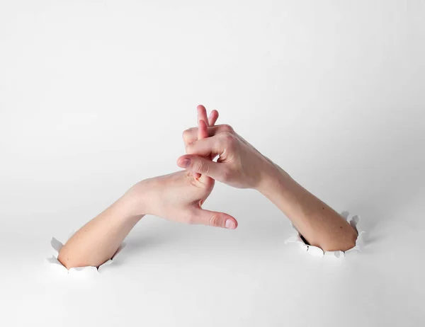 Woman Stretches Her Fingers Torn Holes White Background Creative Art — 스톡 사진