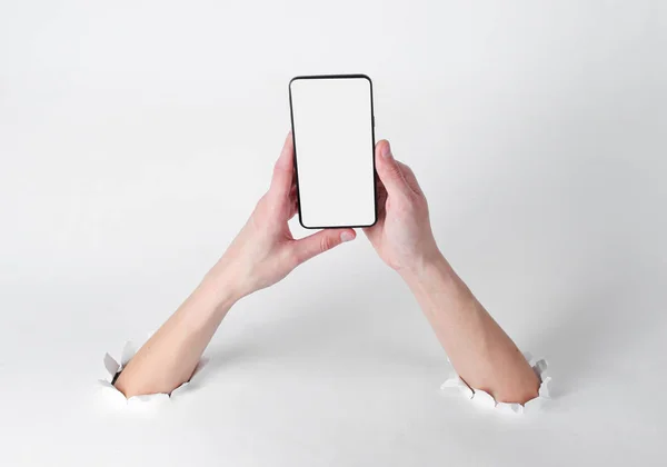 Female Hands Holding Smartphone Torn Holes White Background Creative Art — 스톡 사진