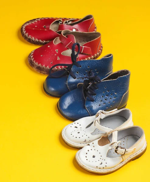 Lot Children Leather Shoes Yellow Background — 스톡 사진