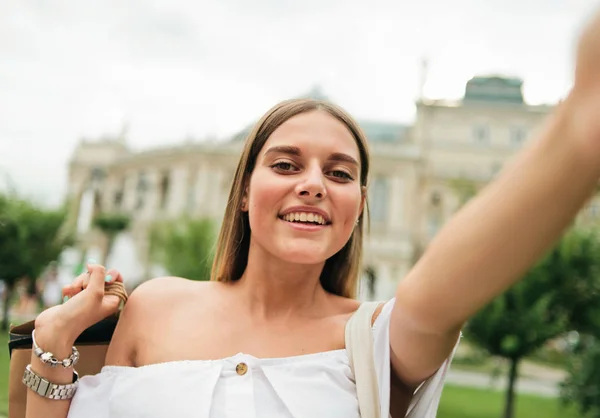Alışveriş Torbalarıyla Neşeli Çekici Bir Kadın Dışarıda Selfie Portresi Çekiyor — Stok fotoğraf
