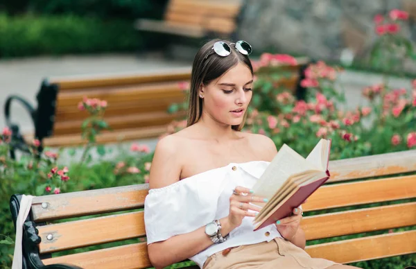 Young Blonde Woman Reading Book Enthusiasm While Sitting Bench Park — Stock Photo, Image