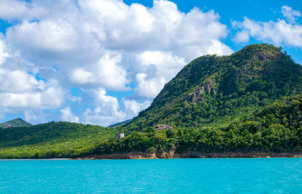 Caribbean islands, Antigua,an ancient watch-tower on the west coast of the island seen from the sea