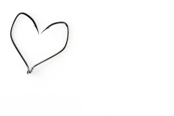 Fishing hooks in the shape of a heart on a white background.