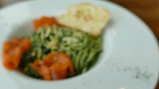 Спагетти с лососем в белой тарелке — стоковое видео