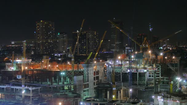 Building cranes in city at night time — Stock Video