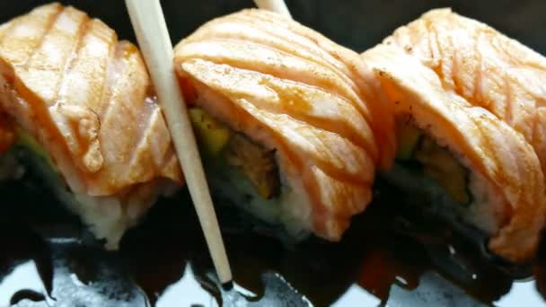 Taking Delicious Fresh Sushi Rolls Bamboo Chopsticks Traditional Japanese Food — Stock Video