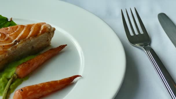 美味的烤鲑鱼牛排配蔬菜在白色的盘子里 — 图库视频影像