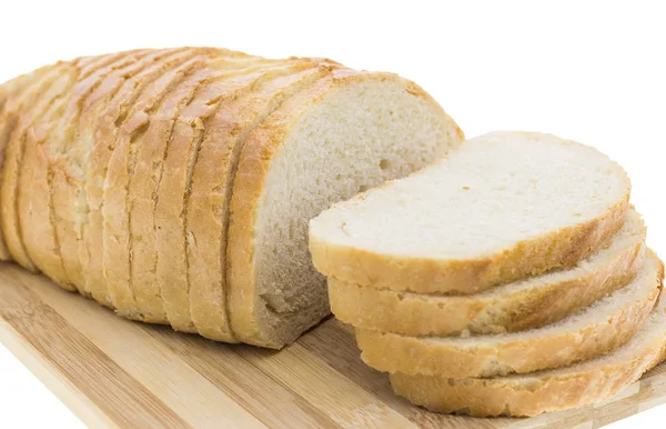 Cutting wheat bread on a white background — Stock Photo, Image