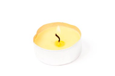A burning candle isolated on white background with light shaddow and reflection clipart