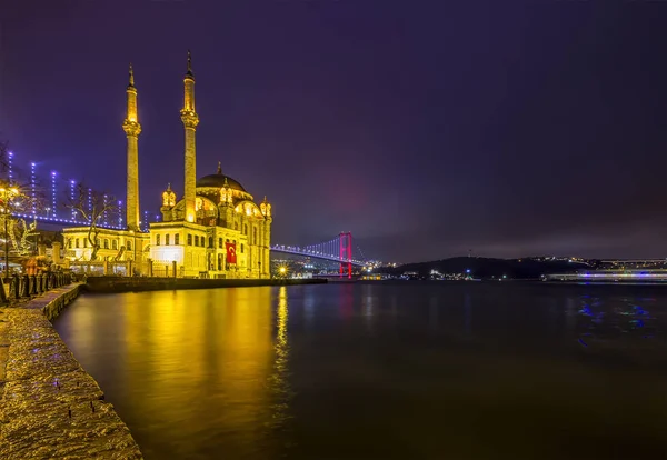 Bild der Ortakoy-Moschee mit Bosporusbrücke in Istanbul bei Nacht. — Stockfoto