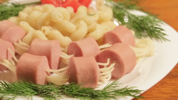 Pasta with sausages. Creative food art idea for children meal top view — Stock Video