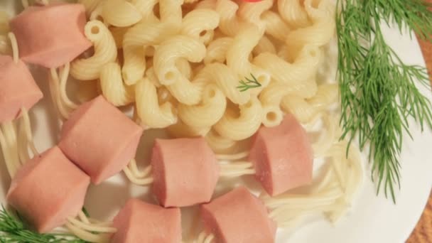 Pasta with sausages. Creative food art idea for children meal top view — Stock Video