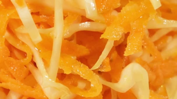 Gemüsesalat aus Möhren und Kohl in weißem Teller auf Holzgrund in Großaufnahme. Vegetarischer gesunder Salat in Pflanzenöl — Stockvideo