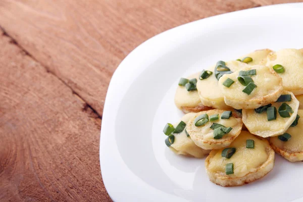 Appetizer of potatoes, cheese and green onions. There is room for text — Stock Photo, Image