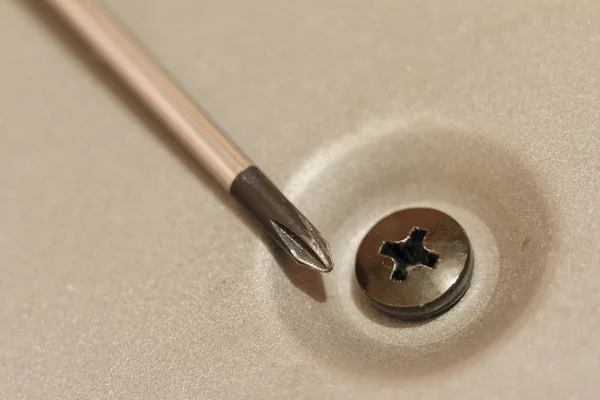 Phillips screwdriver and screw. Macro photography on blurred background. — Stock Photo, Image