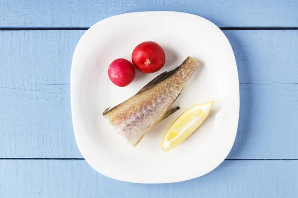 Uncooked ocean fish, radish and lemon on white plate closeup. Inredients for cooking healthy dish. Top view with copy space — Stock Photo, Image