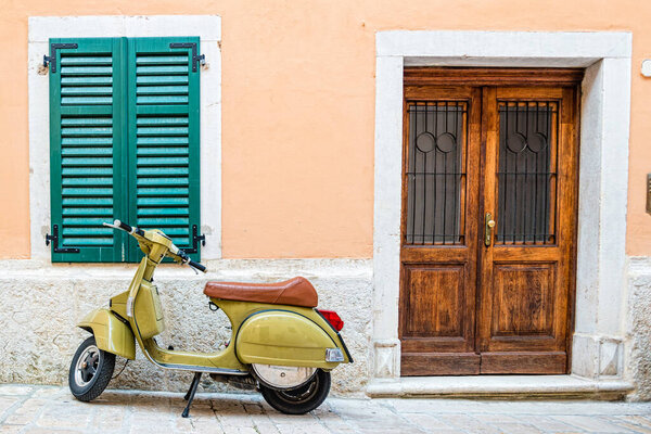 Scooter leaning against a wall in Rovinj, Croatia.