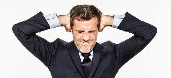 Annoyed young business man covering his ears from corporate burnout — Stock Photo, Image