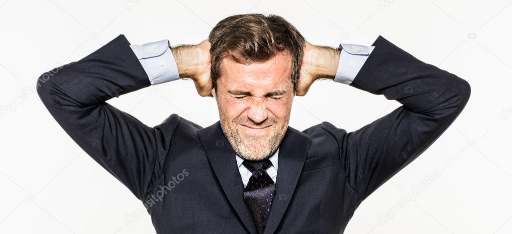 annoyed young business man covering his ears from corporate burnout
