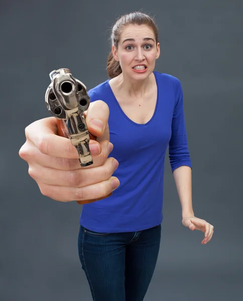 scared young woman with gun expressing anxiety for self-defense