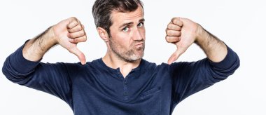 upset handsome young bearded man showing negative thumbs down clipart