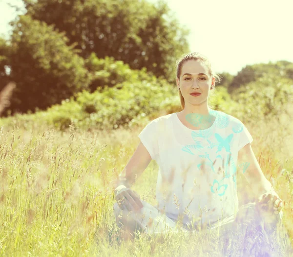 Zen beautiful girl crossed-legged, sunny effects with blue butterflies — Φωτογραφία Αρχείου