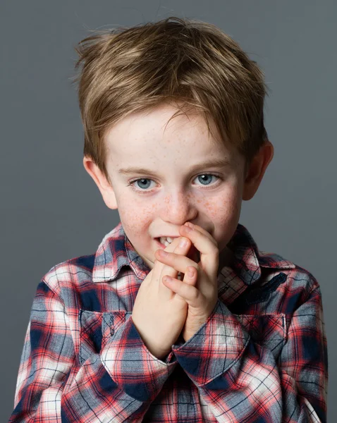 Thinking little boy biting his fingers for boredom or nervousness — ストック写真