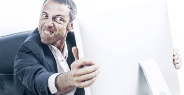enraged businessman with bulging eyes and teeth holding computer clipart