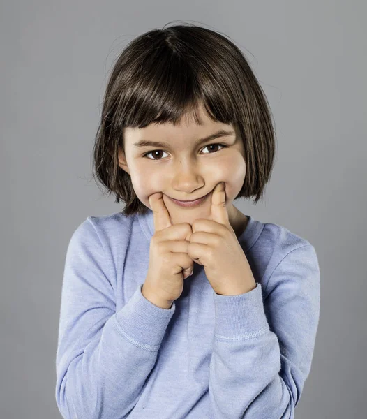 かわいい若い子強制笑顔悲しみや恥ずかしさを非表示にする — ストック写真