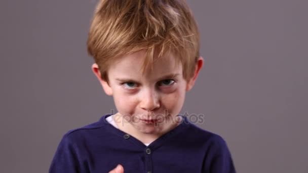 Little kid with freckles showing his boxing hands, grey background — Stock Video