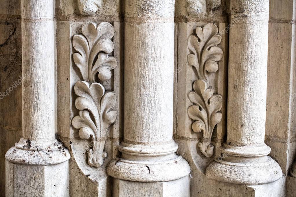 antique building's detail of white limestone pillars or columns