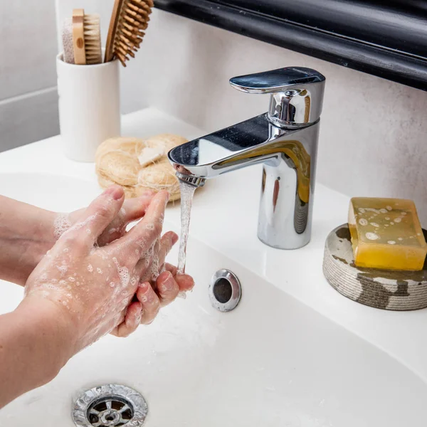 caucasian female hands and fingers foaming and frothing with soap