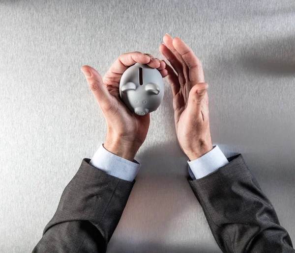 Thinking businessman hands holding a safe piggy bank for investment — Stock Photo, Image